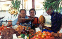 [Men Holding Produce In A Cuban Market]